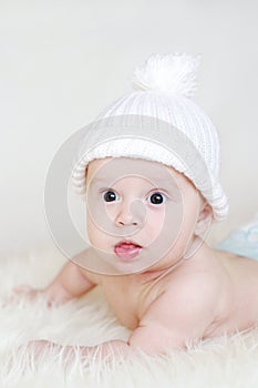 Lovely baby in white knitted hat