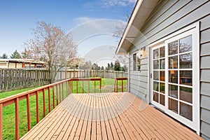 Lovely back yard with deck and grass.
