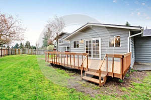 Lovely back yard with deck and grass.