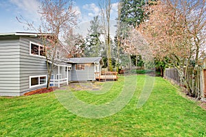 Lovely back yard with deck and grass.
