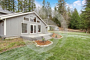 Lovely back yard with porch, and grass.