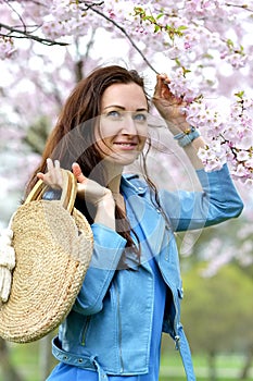 Lovely Beautiful Caucasian Woman Standing Posing on the Background of Blooming Japan Cherry