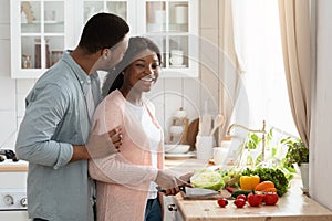 Lovely Black Couple Cooking Salad Together In Kitchen Interior