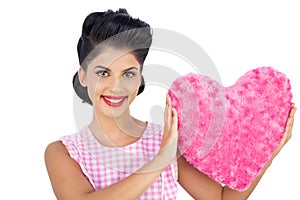 Lovely black hair model holding a pink heart shaped pillow