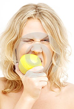 Lovely blond biting lemon