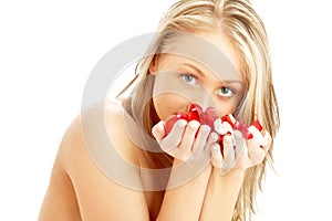 Lovely blond in spa with red and white rose petals