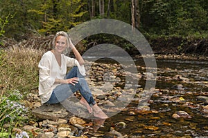 A Lovely Blonde Model Enjoys An Autumn Day Outdoors At The Park