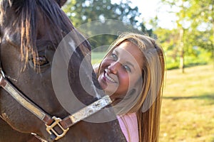 A Lovely Blonde Model Enjoys A Summers Day Outdoors On A Farm With Her Horse
