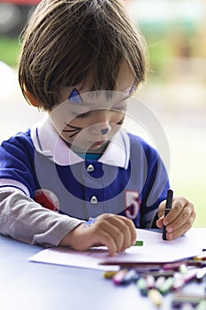 Lovely  Boy Sitting at his Desk Painting
