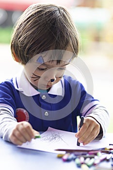 Lovely  Boy Sitting at his Desk Painting