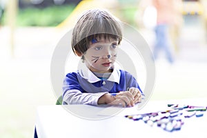 Lovely  Boy Sitting at his Desk Painting