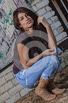 A Lovely Brunette Model Posing Outdoors With The Latest Fashions