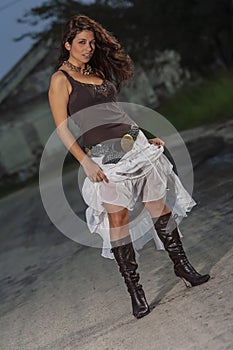 A Lovely Brunette Model Posing Outdoors With The Latest Fashions