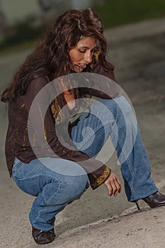 A Lovely Brunette Model Posing Outdoors With The Latest Fashions