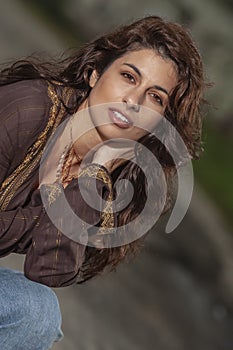 A Lovely Brunette Model Posing Outdoors With The Latest Fashions