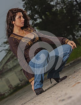 A Lovely Brunette Model Posing Outdoors With The Latest Fashions