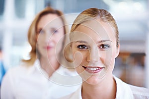 Lovely business woman with female executive. Closeup of lovely young business woman smiling with female executive in