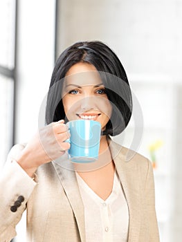 Lovely businesswoman with mug
