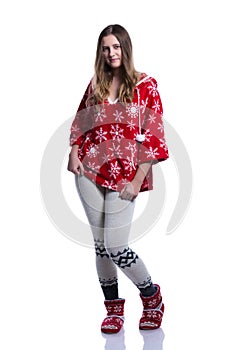 Lovely cheerful teenage girl posing in the studio. Wearing red winter hoodie with snowflakes. Isolated on white background.