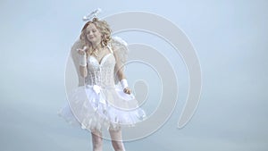 Lovely child. Valentines day card. Little girl with angel wings and halo. A beautiful teen with blonde curly hair and a