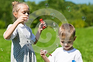 Lovely children blow soap bubbles