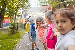 Lovely children playing outdoors at summer camp