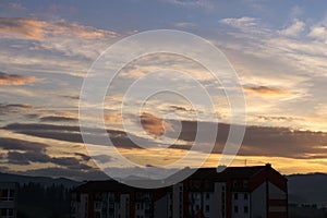 Lovely clouds over the city and houses or park and meadow, during sunrise or sunset.