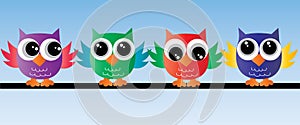 Lovely colorful owls sitting on a branch