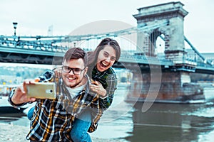 Lovely cople taking selfie bridge on background