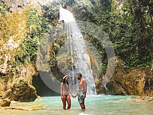 Lovely couple alone in deep forest waterfall, inambakan falls in Cebu Island in Philppines