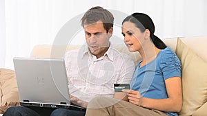 Lovely couple buying something on the internet