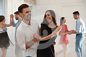 Lovely couple dancing together at party