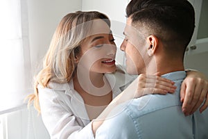 Lovely couple enjoying time together in kitchen at home