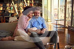 Lovely couple having fun together using a smartphone