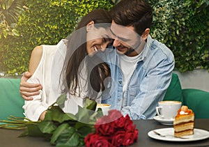 Lovely Couple Hugging Having Romantic Date Sitting In Cafe