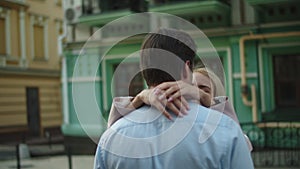 Lovely couple hugging in at street. Man and woman standing together outdoors