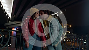 Lovely couple looking eyes to eyes on city background. Pair kissing on street.