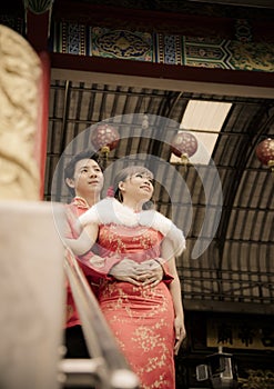 Lovely couple with qipao suit hug in Chinese temple2