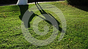 Lovely couple shadow. People walking outdoors in summer day. Silhouette of bride and groom hugging