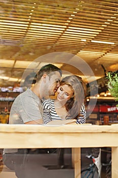 Lovely couple sitting indoors in cafe