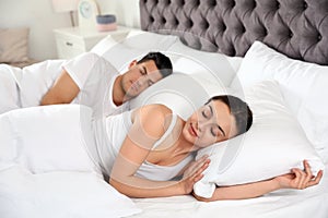 Lovely couple sleeping in large bed