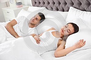Lovely couple sleeping in comfortable bed