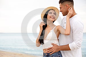 Lovely couple spending time together on beach. Space for text