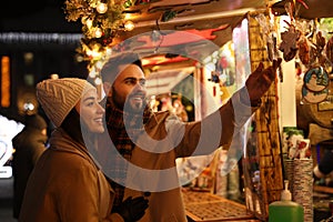 Lovely couple spending time together at Christmas fair