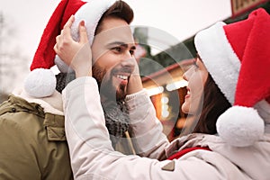 Lovely couple spending time together at Christmas fair