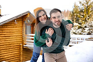 Lovely couple spending time together on snowy day. Winter vacation