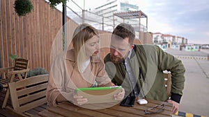 Lovely couple spending time together using tablet.