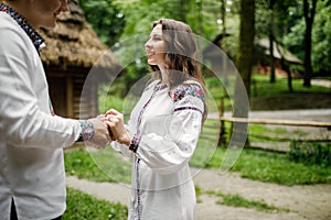 Beautiful bride and groom in the ukrainian style are standing w