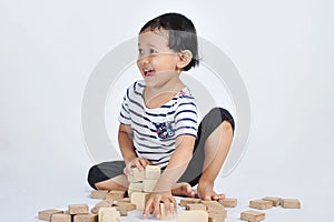 Lovely cute little Asian girl playing wood blocks. Cut Little Asian girl playing wood blocks