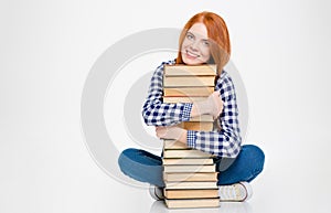 Lovely cute pretty young woman hugging books and smiling